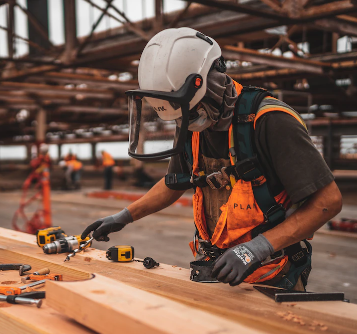 construction worker planing wood